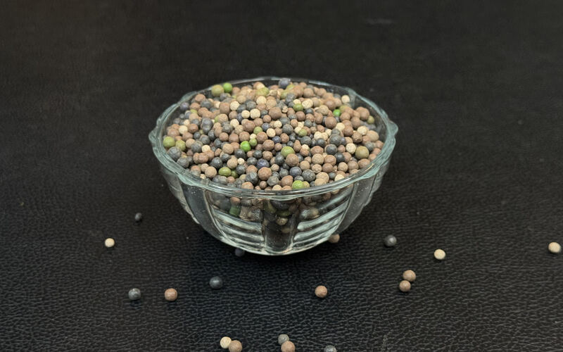 Mixed colour bentonite granules in a glass bowl